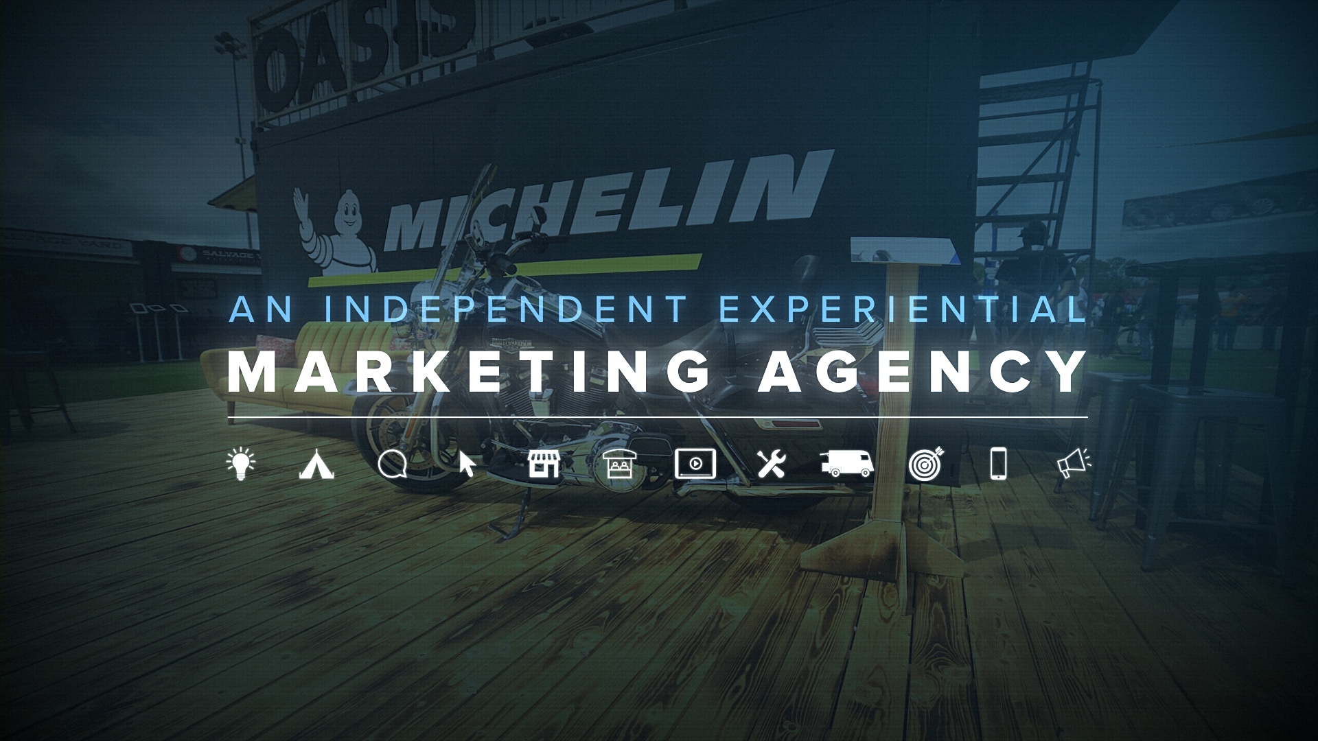 Independent experiential marketing agency text on Michelin branding and motorcycle background, with service icons below the text.